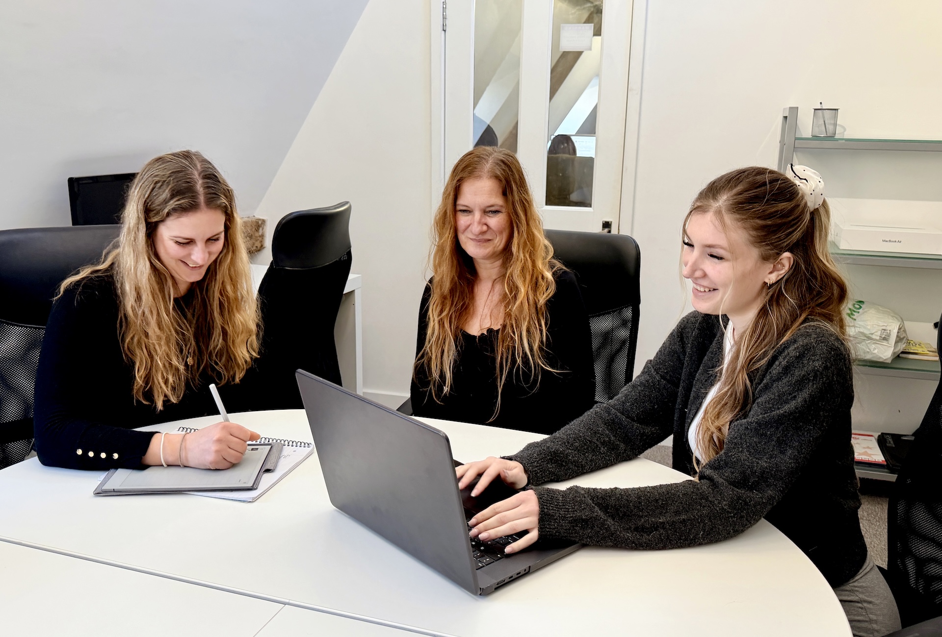 Professionals discussing web development and online strategy in an office